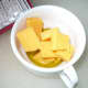 In an oven proof cup add the garlic infused olive oil, one ounce of cheddar cheese,and tablespoon of butter.