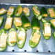 Lay the Stuffed Jalapeno Pepper halves in a single layer on the broiler tray of my convection oven. Drizzel garlic infused olice oil over peppers and sprinkle top with parmesan cheese.