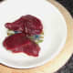 Kangaroo steaks are oiled for griddling