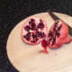 Pomegranate is cut in half to expose seeds