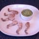 Frogs' legs are plated with guacamole
