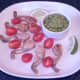 Tomato halves and lime wedges are arranged on the serving plate