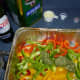 Now add the olive oil, pesto sauce and Pernod. Mix well to blend the ingredients and coat the peppers.