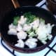 Cauliflower, pak choi and onion are added to pan with duck fat and juices