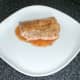 Salmon is laid on sauce bed