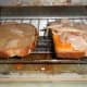 The buttered slice and cheese and turkey slice in the toaster oven.