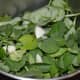 Put the washed fenugreek leaves, garlic cloves and salt in a mixer grinder and crush them.