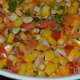 Step six: Garnish with roasted halved peanuts. Corn chaat is ready!