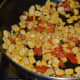 Step four: Add sweet corn kernels. Stir-cook on high flame for 2-3 minutes. Sprinkle a few drops of water, if needed.