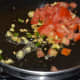 Step three: Add chopped tomatoes. Stir-cook on high flame for 2 minutes or till tomatoes become soft, yet retain crunchiness.