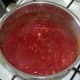 Tomato sauce is simmered until thickened