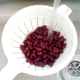 Red kidney beans are washed in running cold water