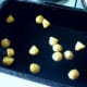 Boiled and cooled potatoes are added to hot oil for roasting