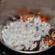 Step 2: Put boiled carrots, grated coconut, roasted spice masala, tamarind, and salt into the mixer or grinder. Grind, adding water little by little to get a near-smooth paste. Transfer it to a bowl.