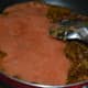 Step six: Pour tomato puree to the pan. Add salt. Stir-cook for 4 minutes.
