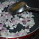 Step three: Add remaining oil to the same pan. Throw in chopped onions. Saute till they become golden brown.