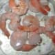 thaw cooked shrimp, remove tails and slice in half along the crease in the back of the shrimp