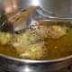 Step three: Take a teaspoon of batter in your fingers. Drop it into the hot oil. Make 6 to 8 such fritters in a batch.