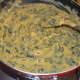 Step 7: Add half a cup of water. Stir the mix. Cover and cook for about 4 minutes or till the gram flour is cooked. Add water to adjust the consistency. This curry should be semi-solid. Once the mix is cooked, turn off the heat.