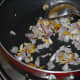 Step four: Add chopped onions. Continue sauteing till onions also become golden brown.