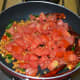 Step two: Add chopped tomatoes. Stir-cook until they become mushy