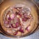 Liver and onions are added to casserole dish and further seasoned with dry thyme.