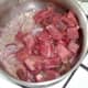 Diced beef is added to the softened onion.