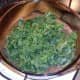 Curly kale is added to the partly-cooked liver casserole.
