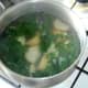 Potatoes and kale are simmered in boiling salted water.