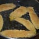 Step six: Deep-fry 5-6 of them in one batch in medium-hot oil. When they are crunchy, remove them to an absorbent paper towel.