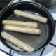 vegan sausages are put on to fry in a little oil