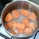 Chopped sweet potatoes ready for boiling