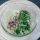 Chickpeas and coriander are added to yoghurt sauce