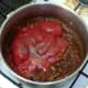 Tomatoes and seasoning are added to onion and spices