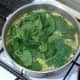 baby spinach leaves are added to simmering rice for the final two minutes of cooking
