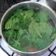 Spinach is added to simmering pasta