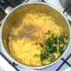 Pepper and coriander are added to cooked and drained turmeric rice