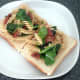 Infused fusilli pasta is arranged on toast