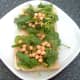 Chickpeas and spinach in tomato sauce are arranged on top of toast