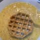 Take the first waffle and dip it in the batter thinly. 