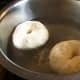 Bagels being boiled in water