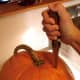 Begin by cutting a slit in the pumpkin near the stem. You may have to stab hard. Make sure your knife is very sharp.