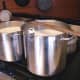 Warming 8 gallons of raw goat's milk to 86 degrees F., before adding yogurt.