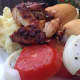 BBQ chicken served with mashed potatoes and tomato and onion salad