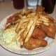 Coleslaw with fried chicken and French fries.
