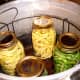 Place jars in a rack in your gently heating pressure canner.   
