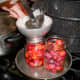 Ladle hot syrup into each jar to cover plums, leaving 1/2" headspace.