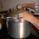 Put on the lid tightly. For lids with knobs, tighten two knobs at a time, in opposite pairs, to keep the pressure even.