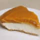 Serving of layered pumpkin pie with cream cheese layer topped with pumpkin-pudding layer