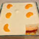 Layered mandarin and lemon dessert decorated with mandarin slices